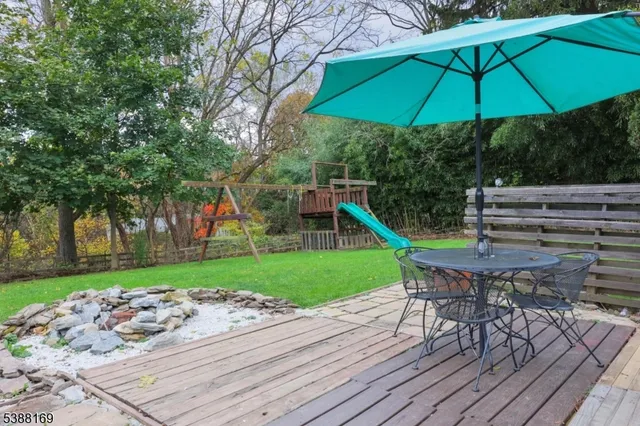 a view of a backyard with furniture and a table