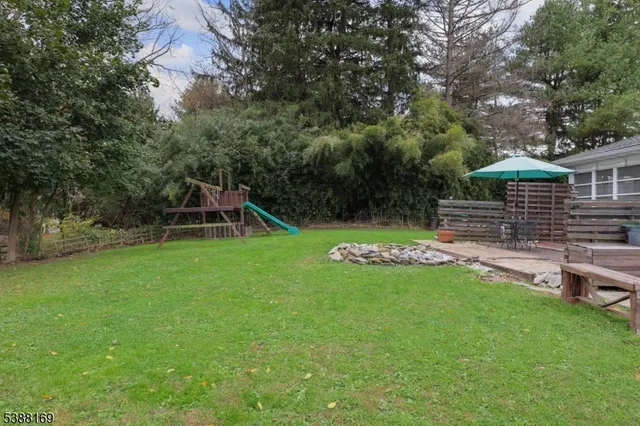 a view of a backyard with a garden and entertaining space