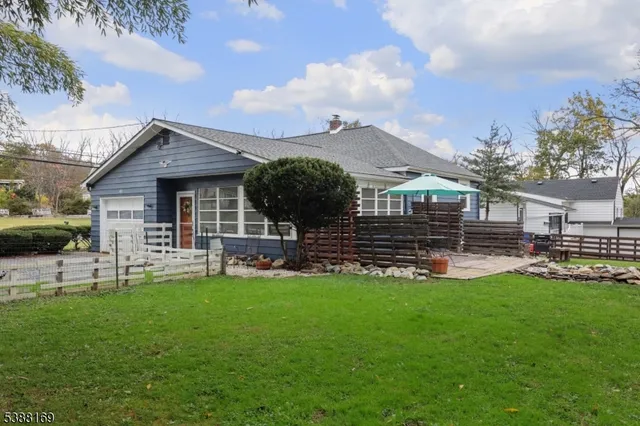 a front view of a house with a yard porch and sitting area
