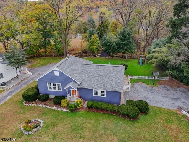 an aerial view of a house next to a big yard