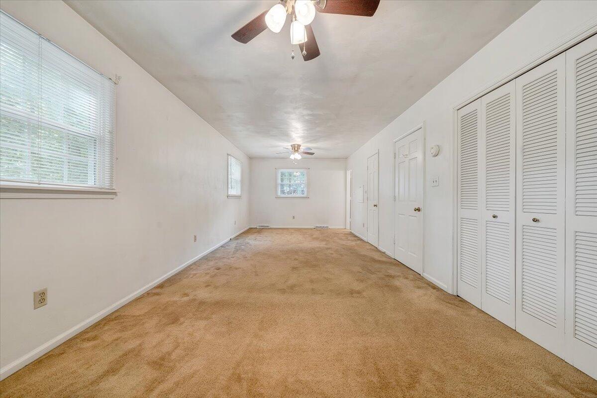 869 Lakeshore Terrace Road Hardy, VA 24101 - Photo 24 of 58 an empty room with a chandelier fan and windows