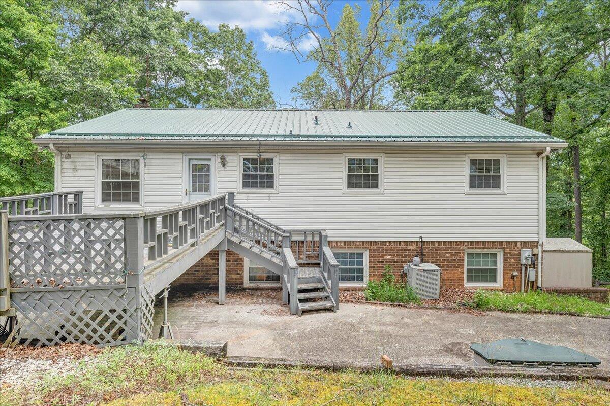 869 Lakeshore Terrace Road Hardy, VA 24101 - Photo 49 of 58 a view of a house with wooden deck and a yard