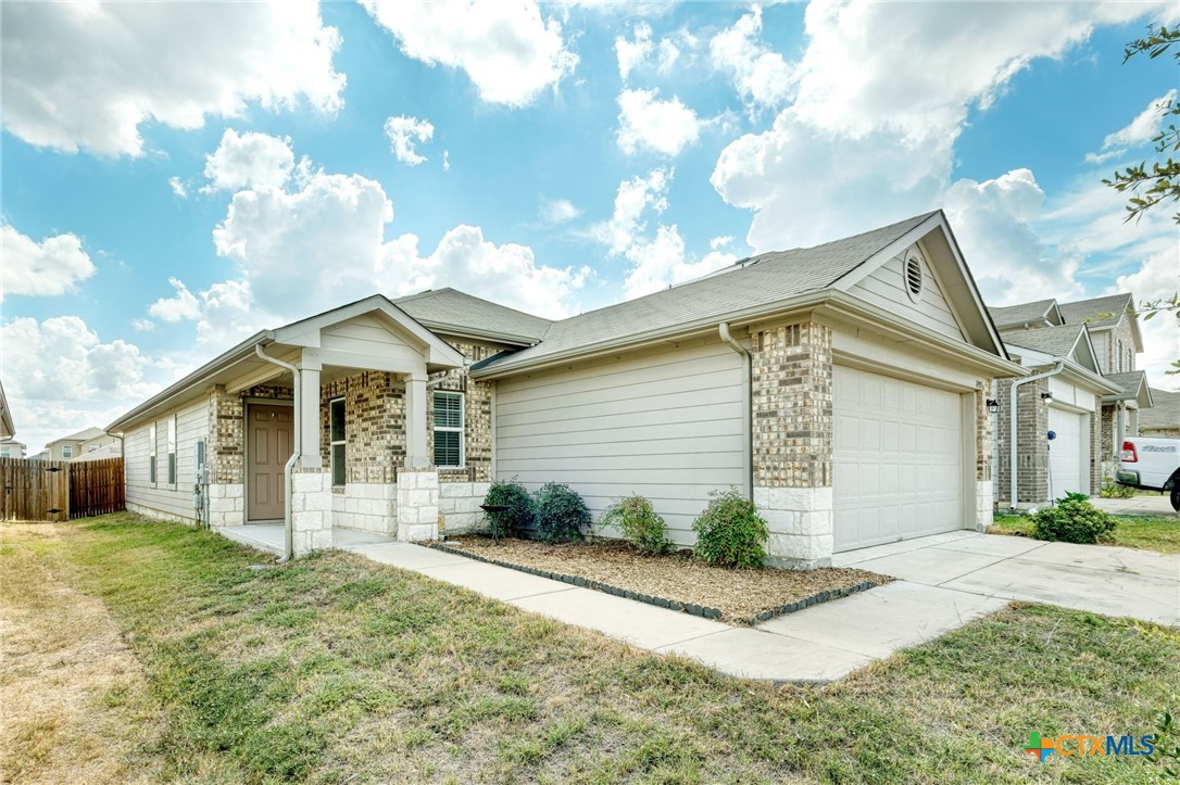14905 Breccia Road Manor, TX 78653 - Photo 2 of 13 Inviting walkway leading up to the front door with a covered entry.
