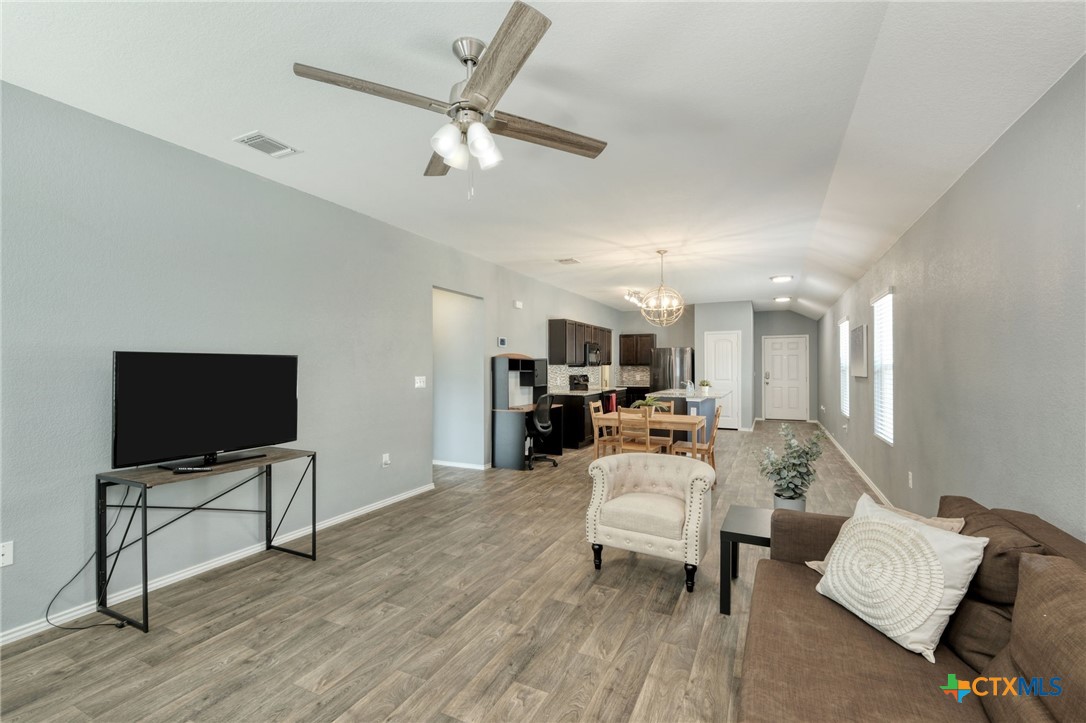 14905 Breccia Road Manor, TX 78653 - Photo 12 of 13 The open concept floor plan is perfect for entertaining with a seamless transition between the living room , dining area, and kitchen.
