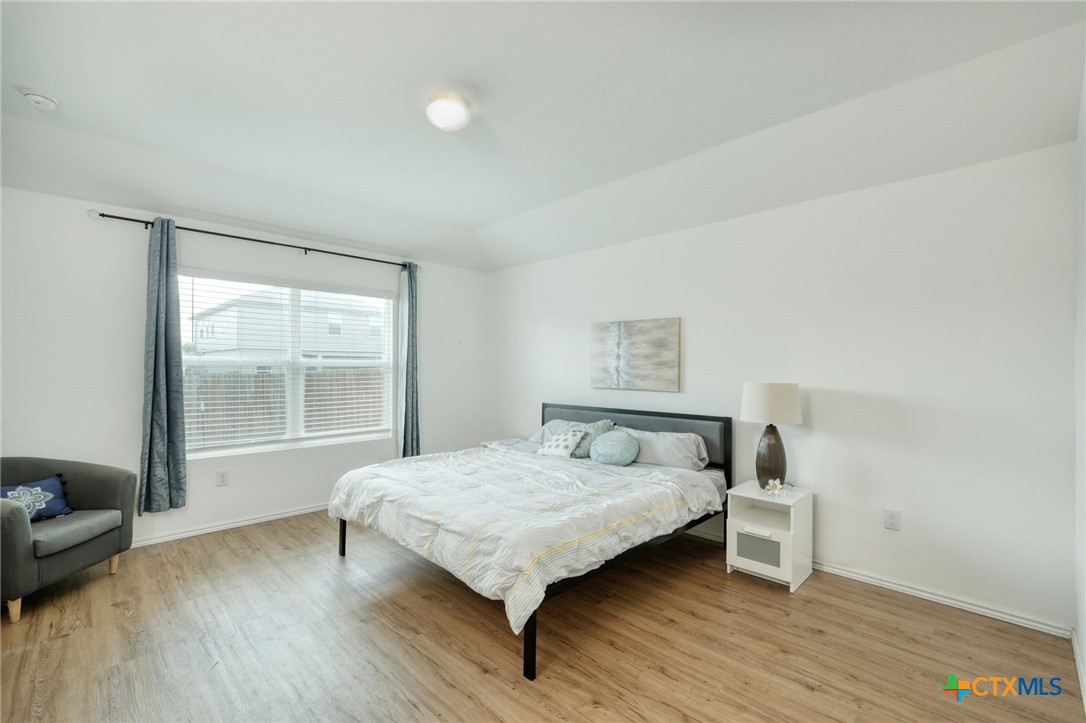14905 Breccia Road Manor, TX 78653 - Photo 5 of 13 The primary bedroom has a large window overlooking the backyard and Vinyl flooring throughout.