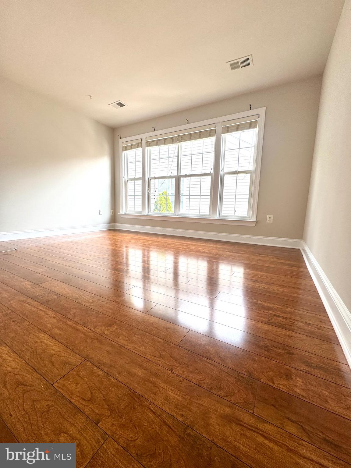 12447 Red Patch Lane Fairfax, VA 22033 - Photo 13 of 34 an empty room with wooden floor and windows