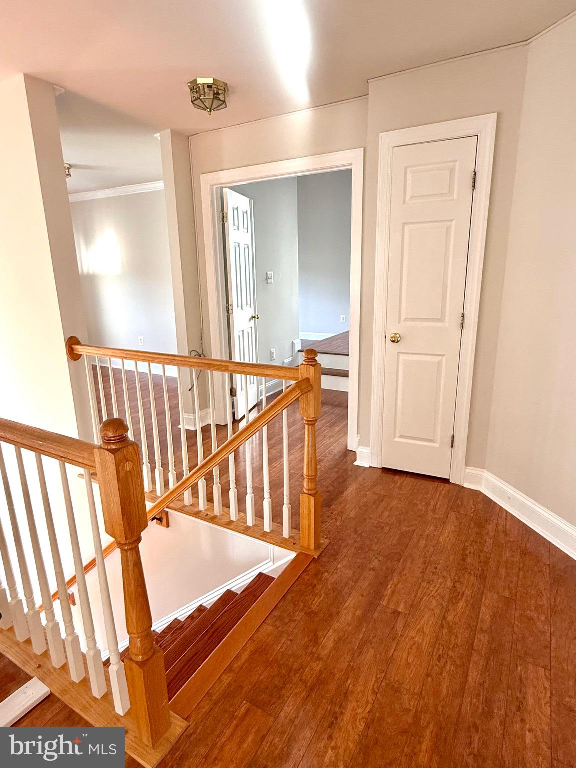 12447 Red Patch Lane Fairfax, VA 22033 - Photo 17 of 34 a view of a hallway with wooden floor and staircase