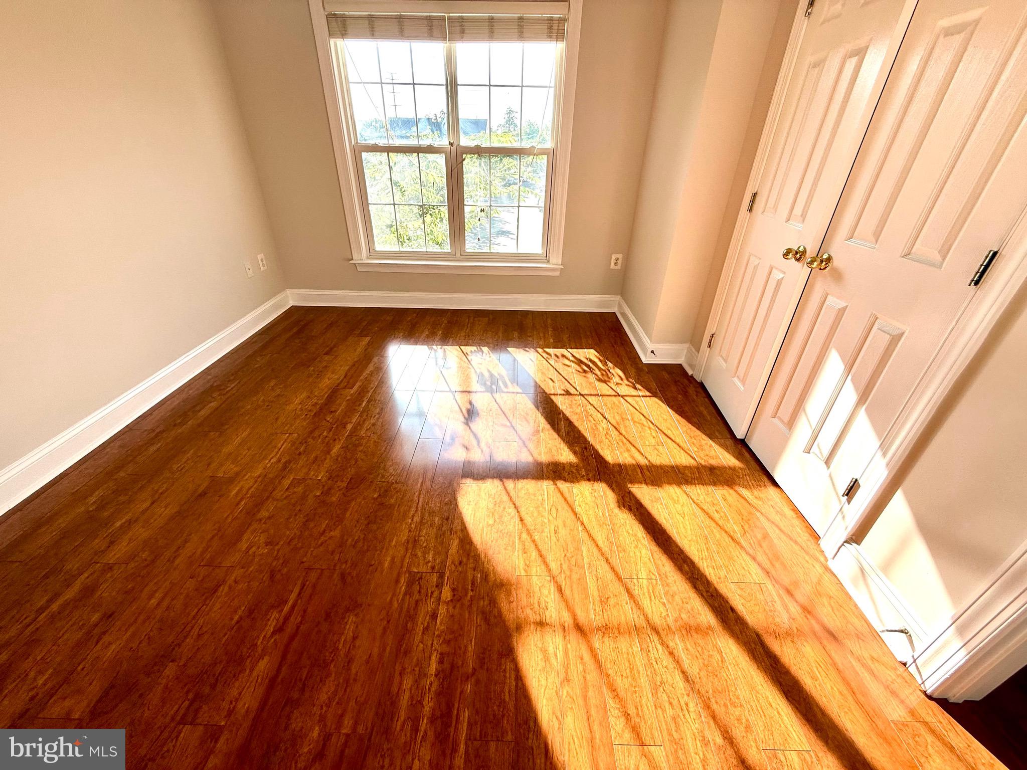12447 Red Patch Lane Fairfax, VA 22033 - Photo 21 of 34 a view of an empty room with wooden floor and a window