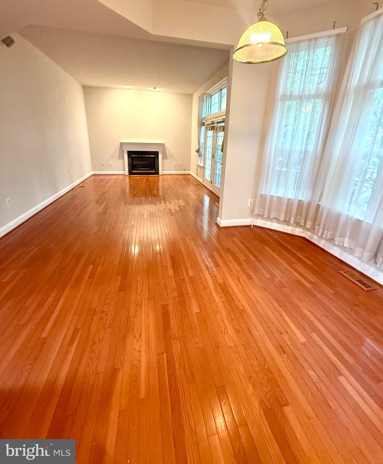12447 Red Patch Lane Fairfax, VA 22033 - Photo 3 of 34 a view of empty room with wooden floor and fan