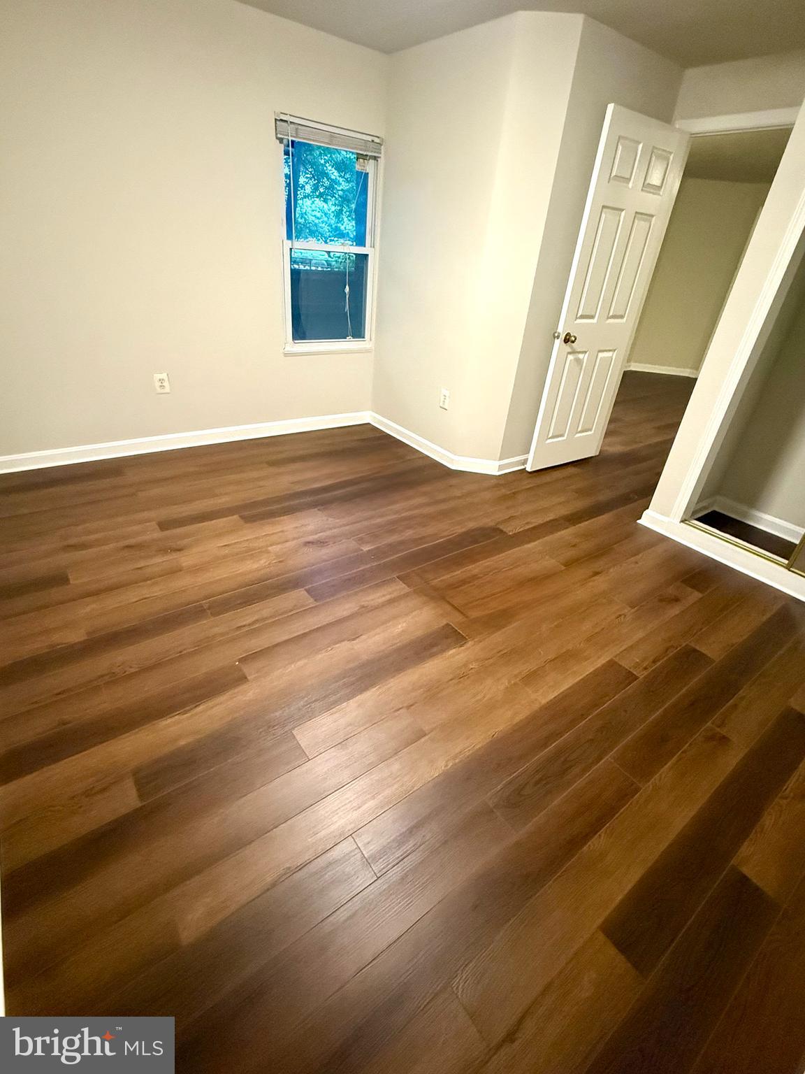 12447 Red Patch Lane Fairfax, VA 22033 - Photo 32 of 34 a view of an empty room with wooden floor and a window