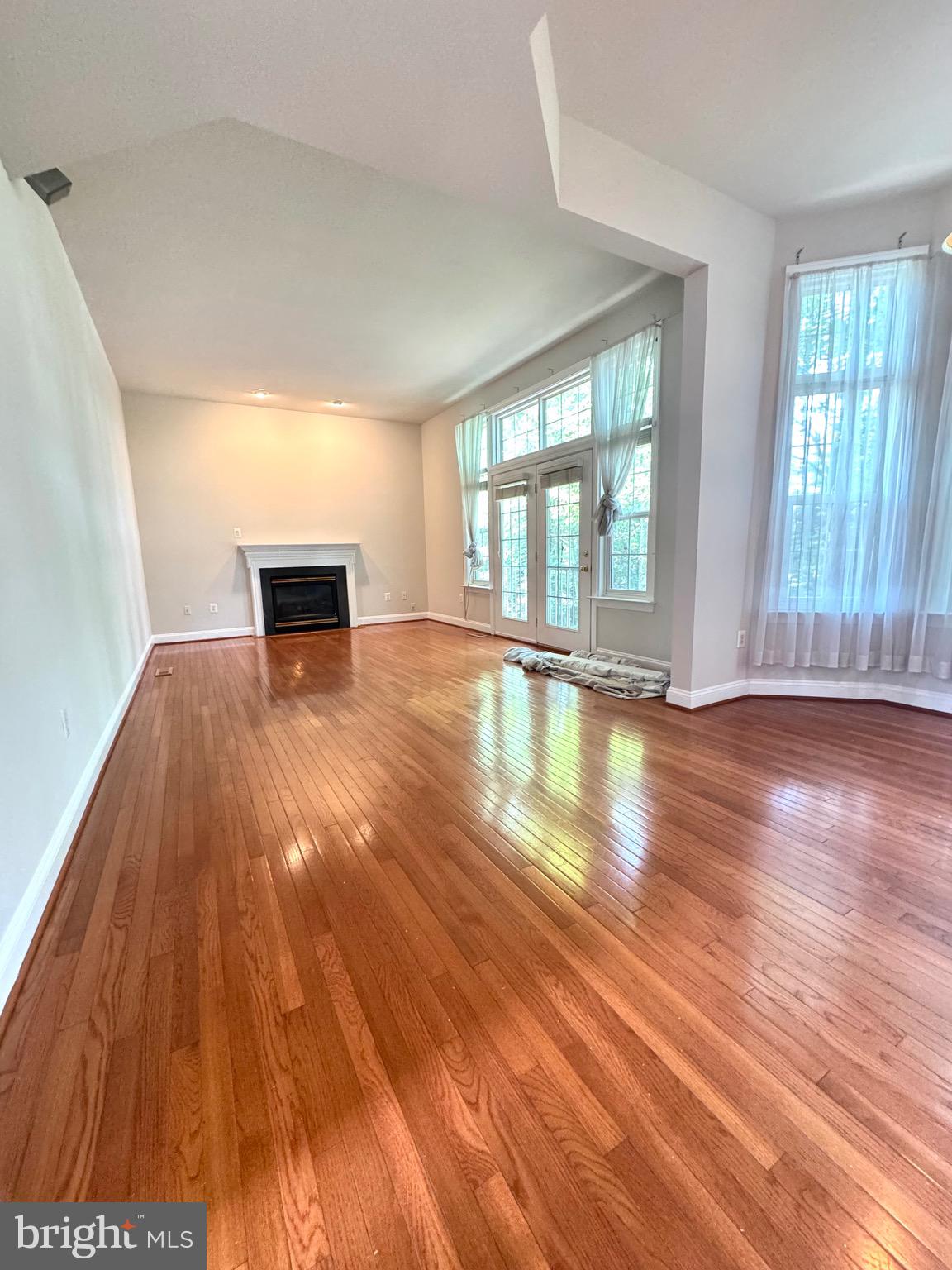 12447 Red Patch Lane Fairfax, VA 22033 - Photo 4 of 34 a view of empty room with wooden floor and fan