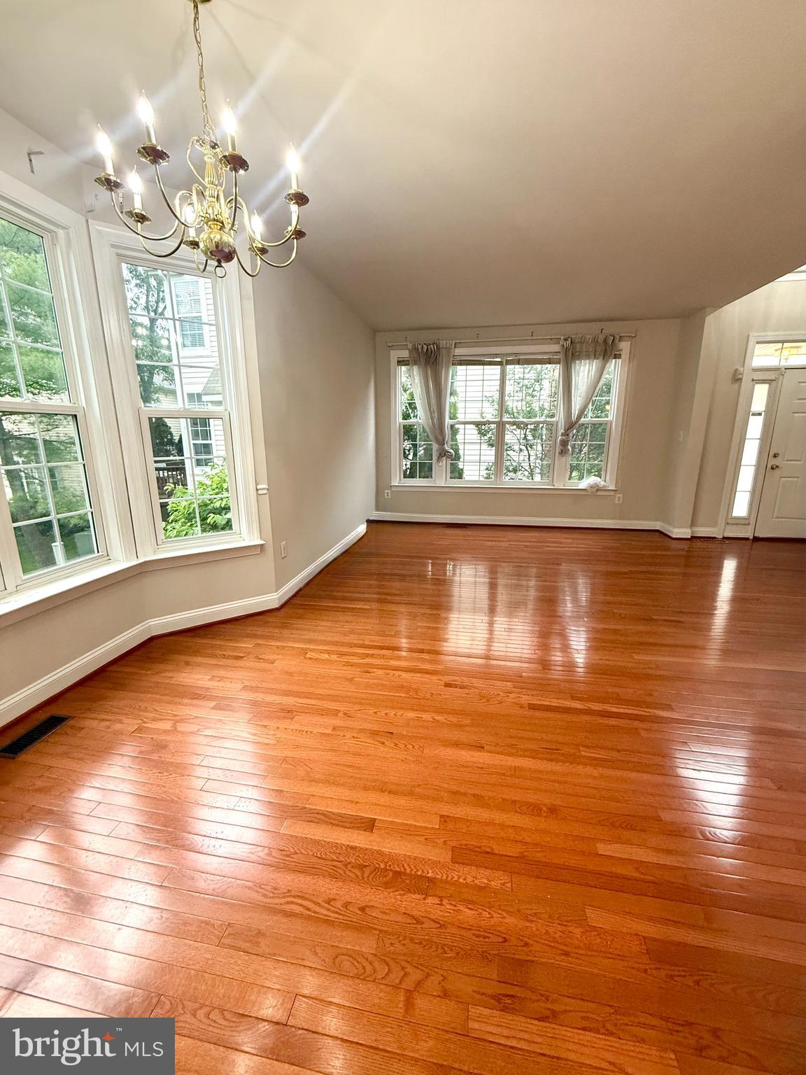12447 Red Patch Lane Fairfax, VA 22033 - Photo 5 of 34 an empty room with wooden floor and windows