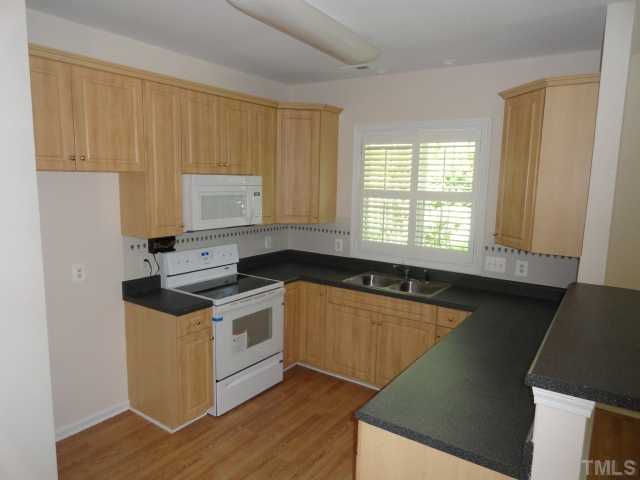 2911 Andover Glen Road Raleigh, NC 27604 - Photo 3 of 10 a kitchen with a stove a sink and a window