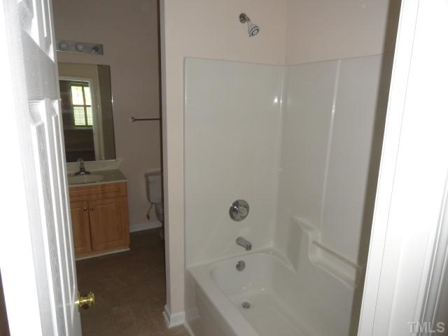 2911 Andover Glen Road Raleigh, NC 27604 - Photo 6 of 10 a bathroom with a bathtub and a shower