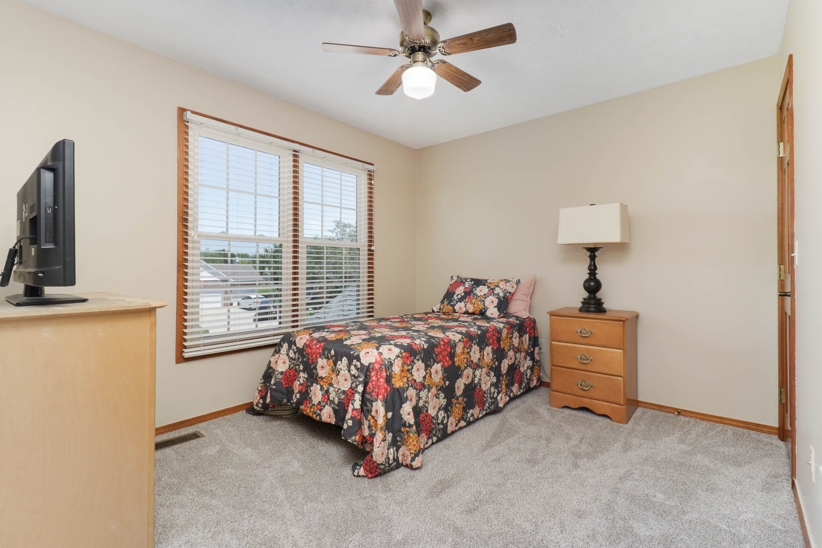 3203 Eagle Crest Road Bloomington, IL 61704 - Photo 30 of 52 a bed sitting in a bedroom next to a window
