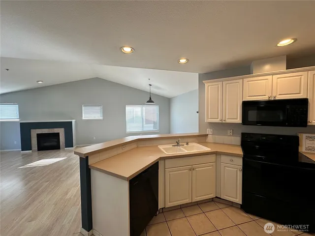 a kitchen with a stove and a refrigerator