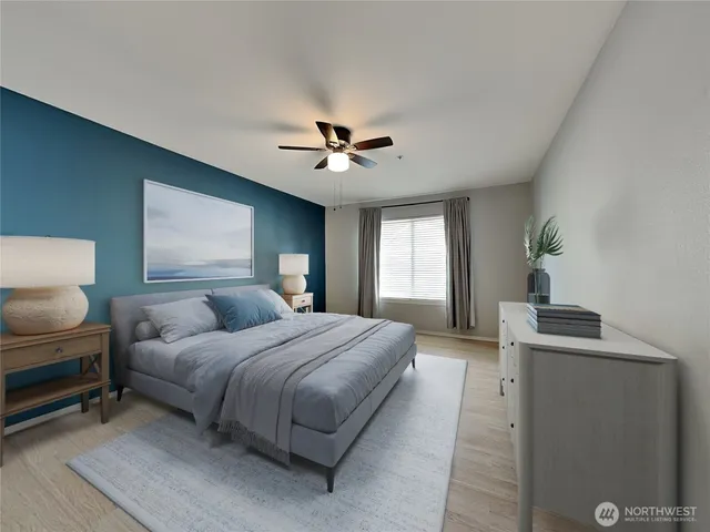 a bedroom with a bed and a chandelier