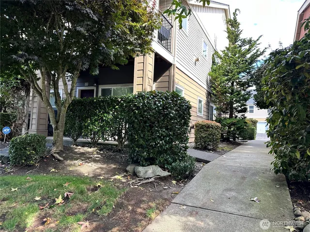 a view of a white house with a yard