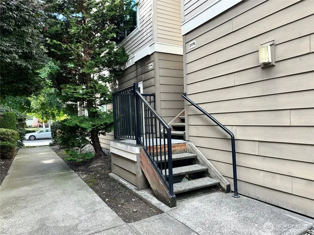 a view of a house with backyard and deck