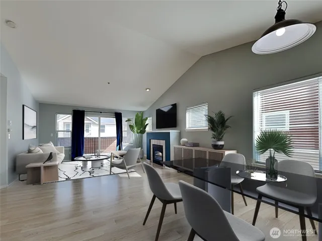 a living room with furniture a large window and a fireplace