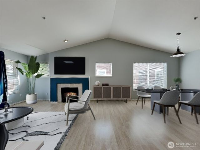 a living room with furniture a fireplace and a flat screen tv