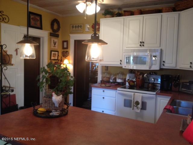41 Rohde Avenue St. Augustine, FL 32084 - Photo 5 of 16 a kitchen with stainless steel appliances granite countertop a stove and cabinets