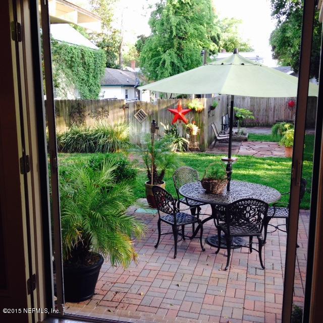 41 Rohde Avenue St. Augustine, FL 32084 - Photo 7 of 16 a view of a patio with table and chairs under an umbrella