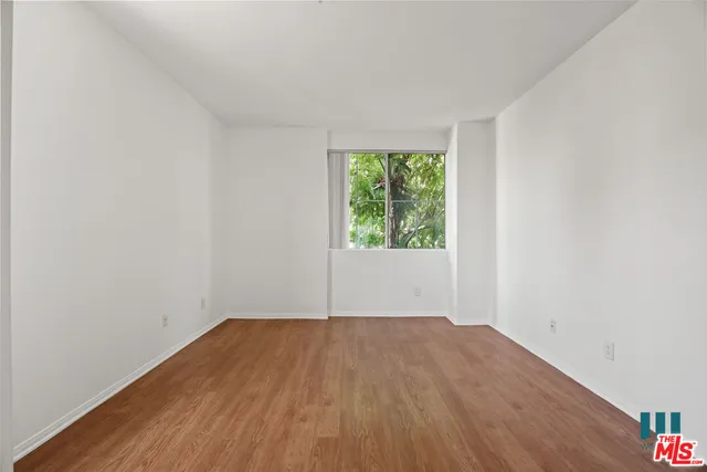 a view of a room with wooden floor and window