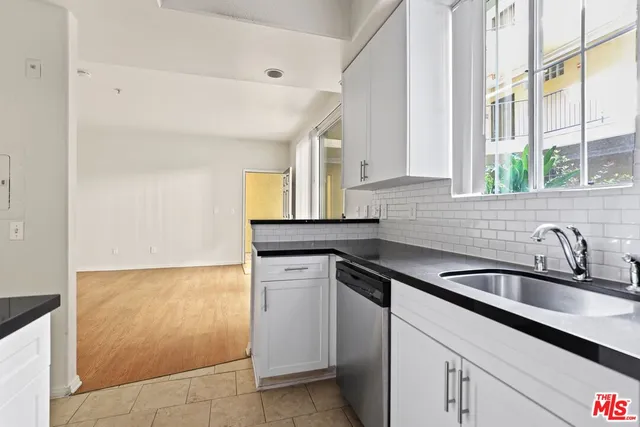 a kitchen with a sink and cabinets