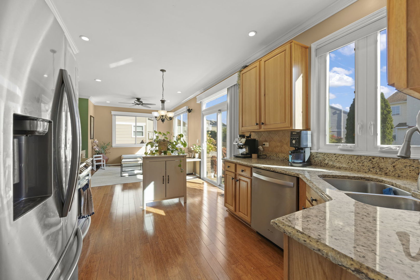 2723 Rosehall Lane Aurora, IL 60503 - Photo 8 of 23 a view of a kitchen with kitchen island granite countertop a large window a sink and stainless steel appliances