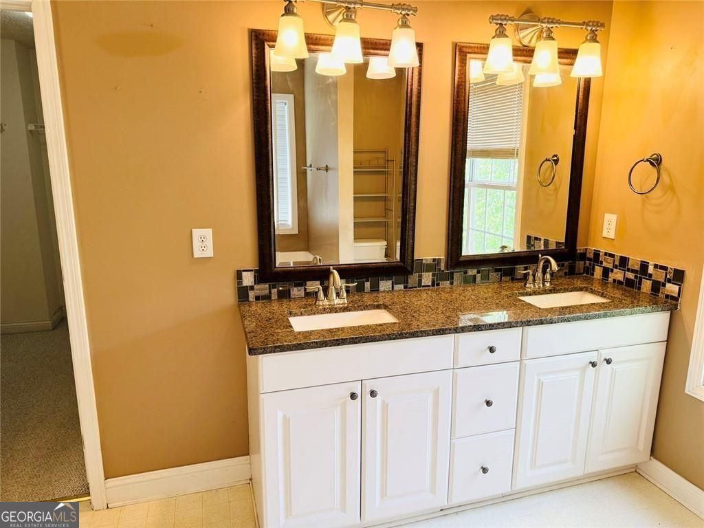 543 Saddle Ridge Drive Bethlehem, GA 30620 - Photo 23 of 36 a bathroom with double sink and a mirror