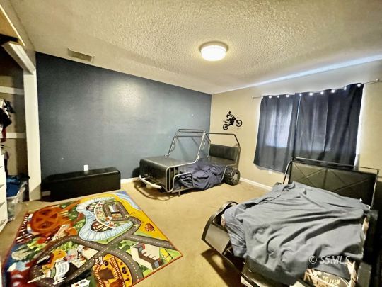 521 Scott Street Ridgecrest, CA 93555 - Photo 18 of 33 a bedroom with double bed and a dresser