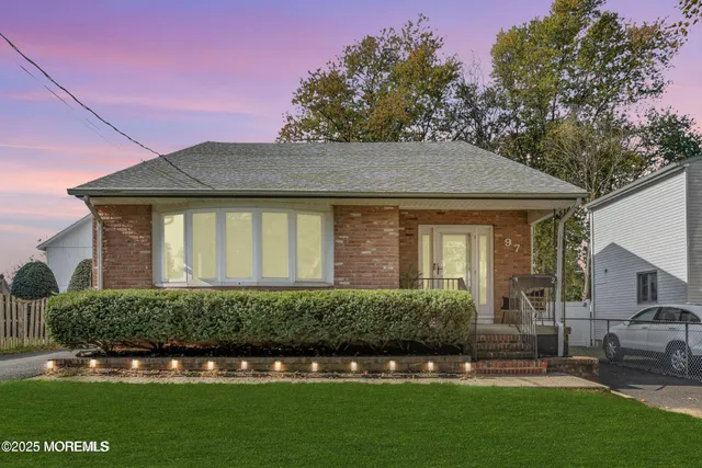 a front view of a house with a garden