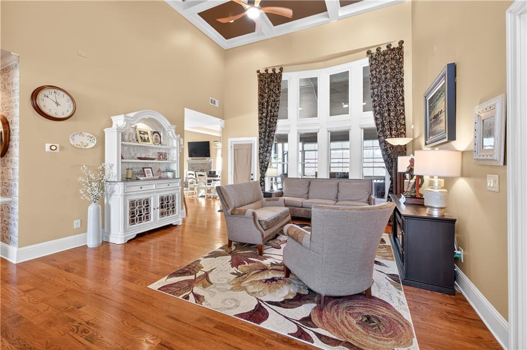 905 Old Forge Lane Jefferson, GA 30549 - Photo 11 of 69 a living room with couches and a dining table with wooden floor
