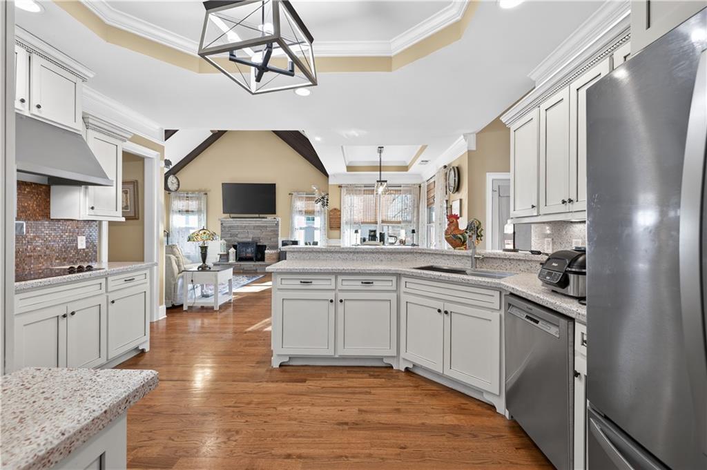 905 Old Forge Lane Jefferson, GA 30549 - Photo 17 of 69 a kitchen with granite countertop a sink cabinets stainless steel appliances and a counter top space