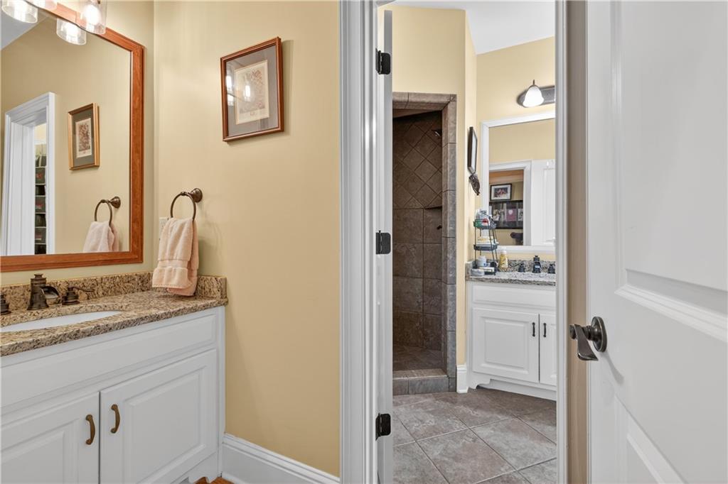 905 Old Forge Lane Jefferson, GA 30549 - Photo 29 of 69 a bathroom with a granite countertop sink and a mirror
