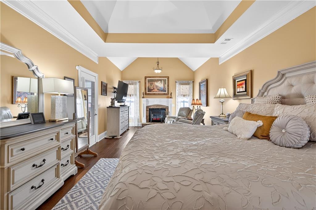 905 Old Forge Lane Jefferson, GA 30549 - Photo 31 of 69 a spacious bedroom with a bed and a fireplace