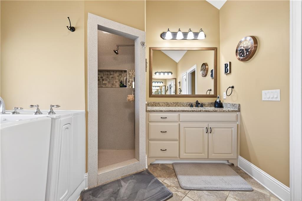 905 Old Forge Lane Jefferson, GA 30549 - Photo 36 of 69 a spacious bathroom with a mirror a sink and a mirror