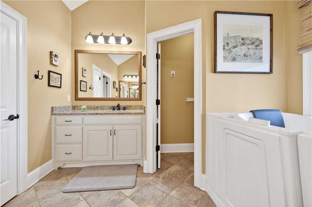 905 Old Forge Lane Jefferson, GA 30549 - Photo 37 of 69 a spacious bathroom with a granite countertop sink and a mirror