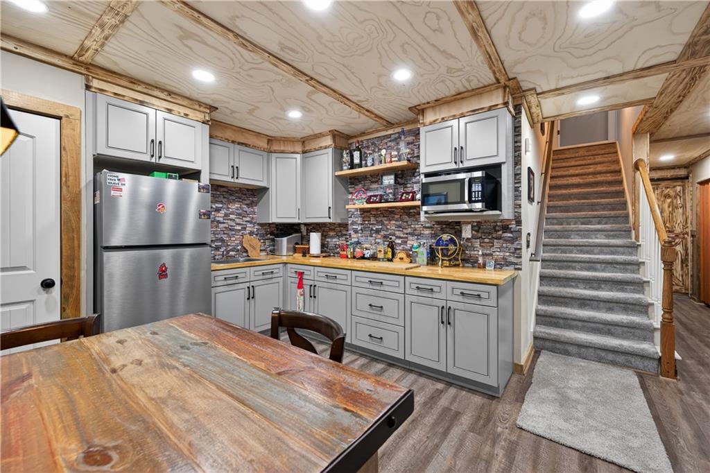 905 Old Forge Lane Jefferson, GA 30549 - Photo 42 of 69 a kitchen with granite countertop stainless steel appliances and wooden cabinets