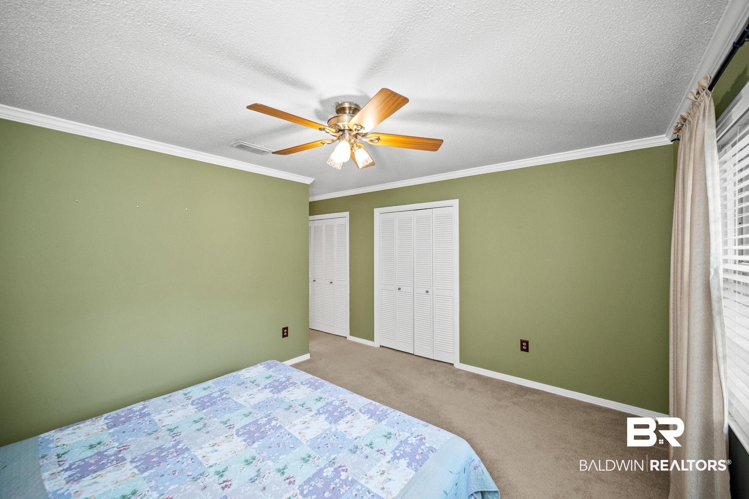303 West Palm Avenue Foley, AL 36535 - Photo 17 of 32 Bedroom featuring two closets, ornamental molding, carpet floors, and ceiling fan