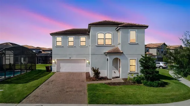 a front view of a house with a yard and garage