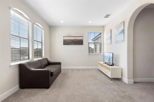 a bedroom with a bed lamp and a window