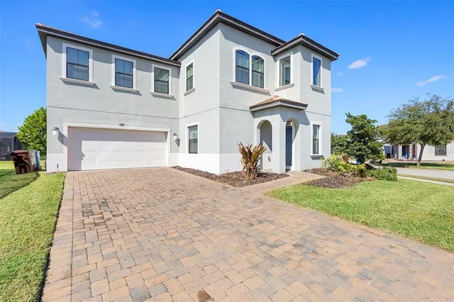 a kitchen with stainless steel appliances kitchen island granite countertop a table chairs and a refrigerator