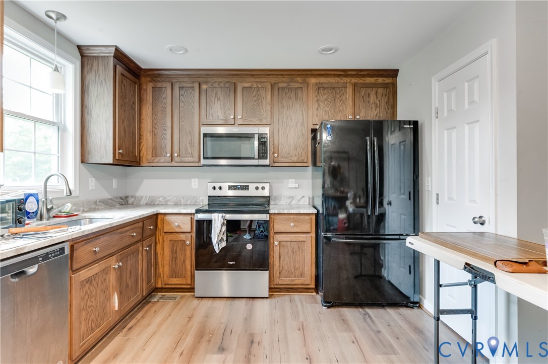 24580 St James Road Jetersville, VA 23083 - Photo 9 of 25 Kitchen featuring wood-finish cabinetry, light-ton