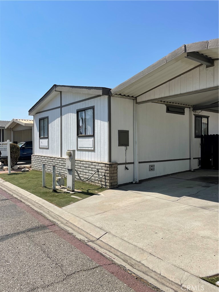 7717 Church Avenue, Unit 54 Highland, CA 92346 - Photo 2 of 13 a front view of a house with a yard