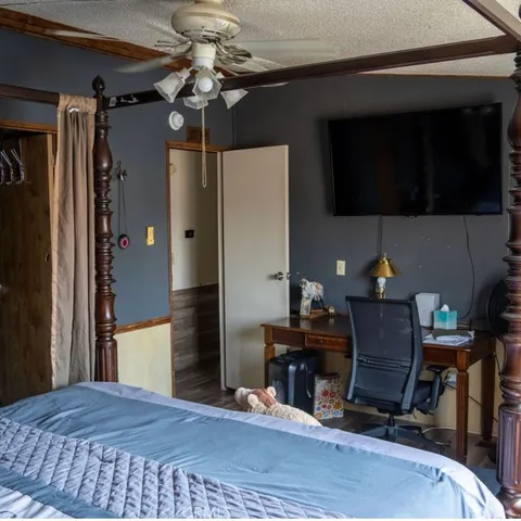 a bedroom with a bed and a chandelier