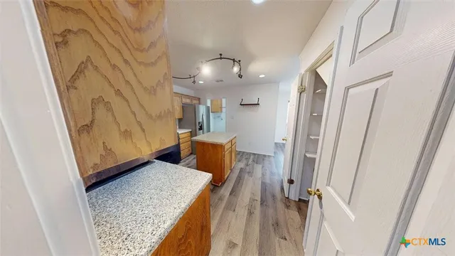 a view of a kitchen from the hallway