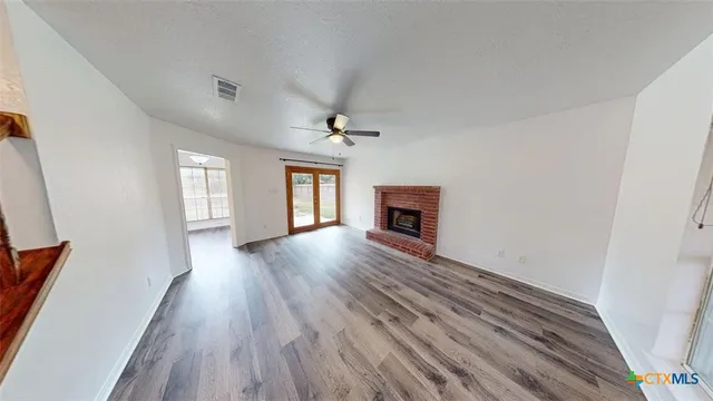 a view of livingroom with hardwood floor and a ceiling fan