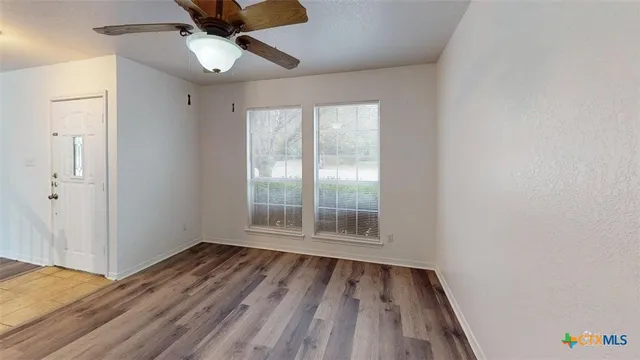 wooden floor in an empty room with a window